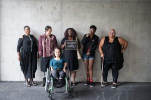Line up of six disabled people showing disability pride